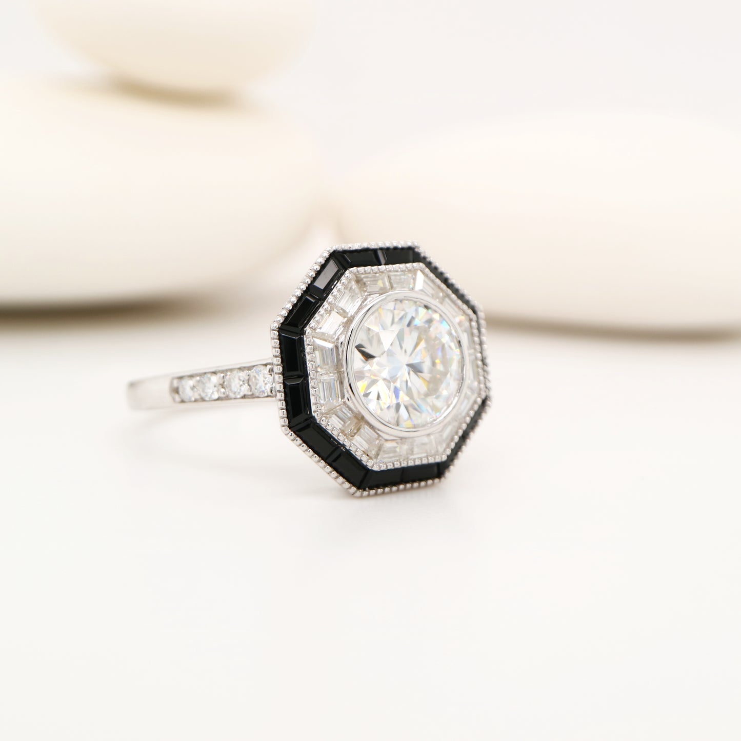 Moissanite target ring with moissanite and onyx halo in white gold