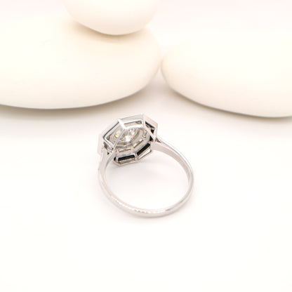 Moissanite target ring with moissanite and onyx halo in white gold