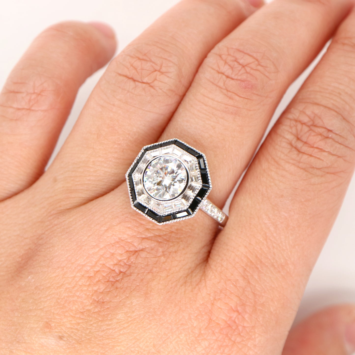 Moissanite target ring with moissanite and onyx halo in white gold