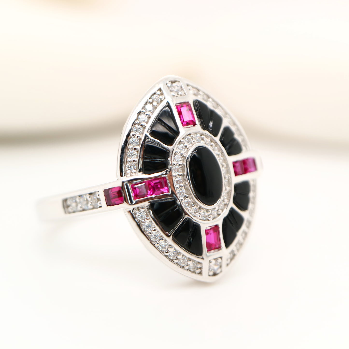 Onyx, ruby and diamond shield target ring in white gold