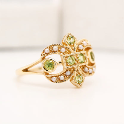 Gold fleur-de-lis ring with peridot and pearl