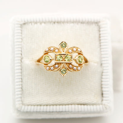 Gold fleur-de-lis ring with peridot and pearl