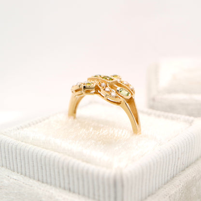 Gold fleur-de-lis ring with peridot and pearl