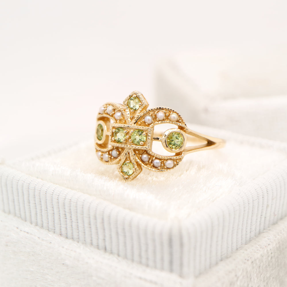 Gold fleur-de-lis ring with peridot and pearl