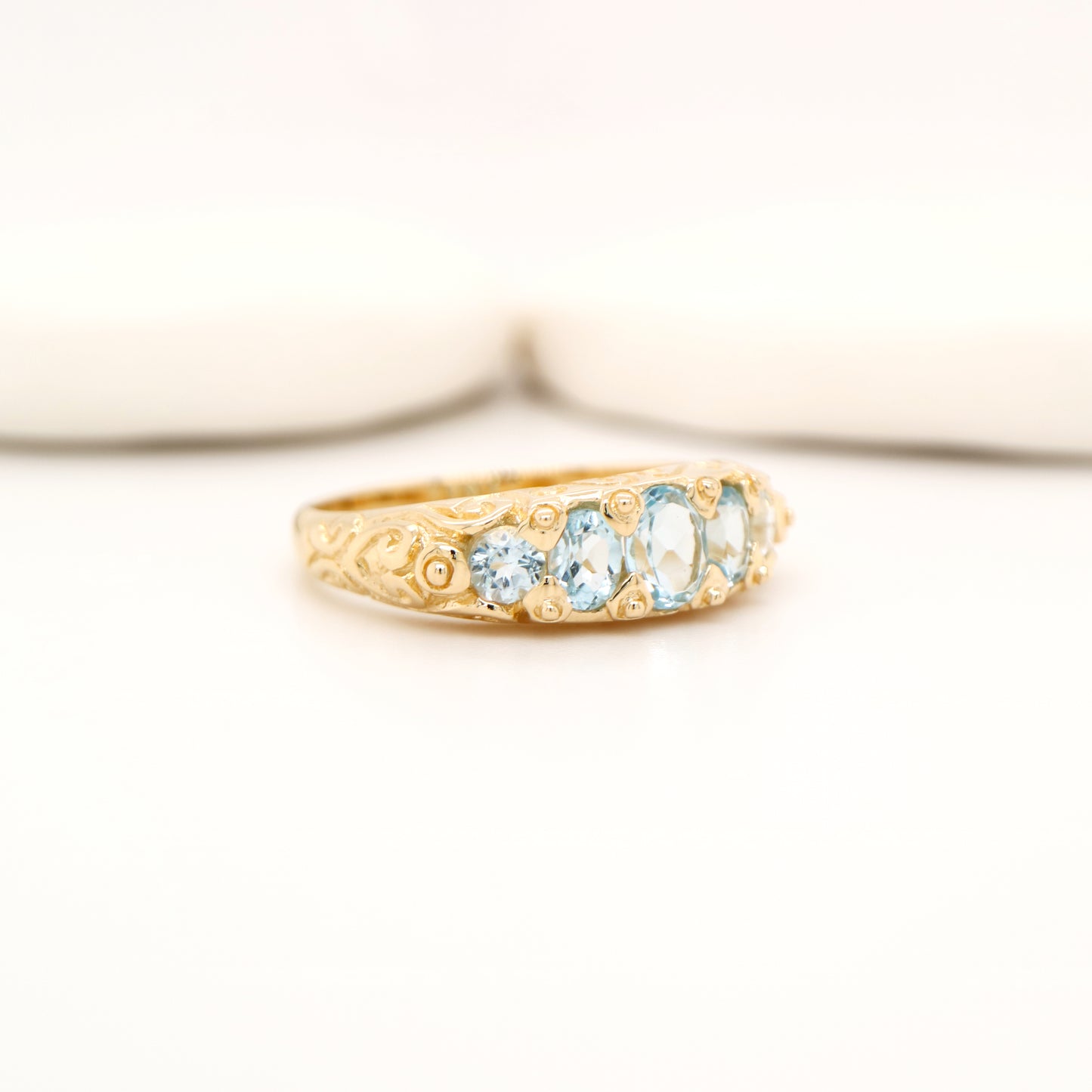 Vintage cascading sky blue topaz ring in yellow gold