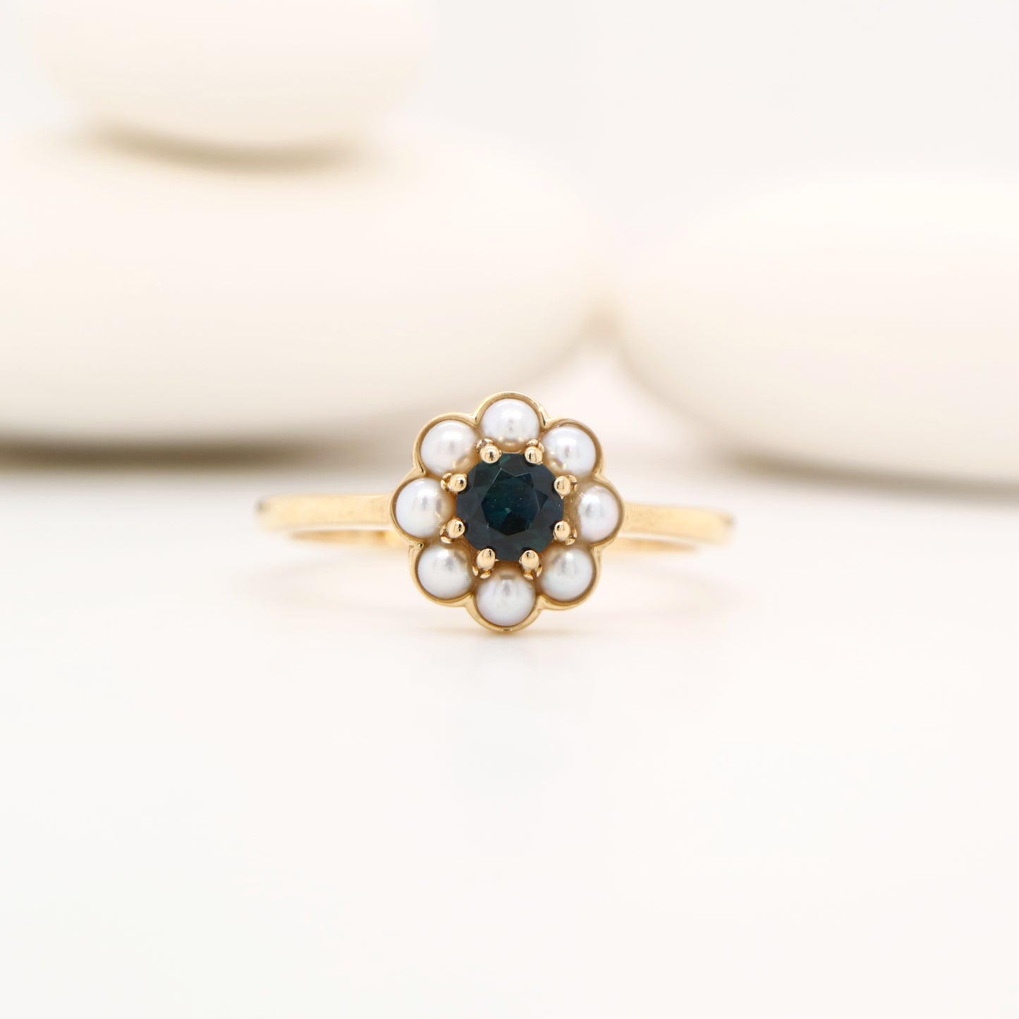 Blue sapphire with pearl halo ring in 9k yellow gold