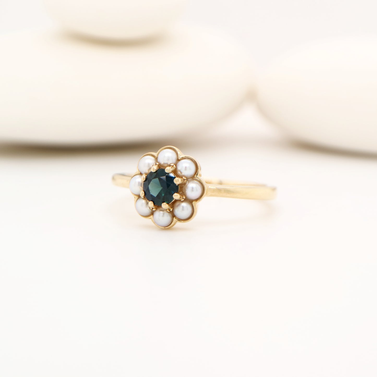 Blue sapphire with pearl halo ring in 9k yellow gold