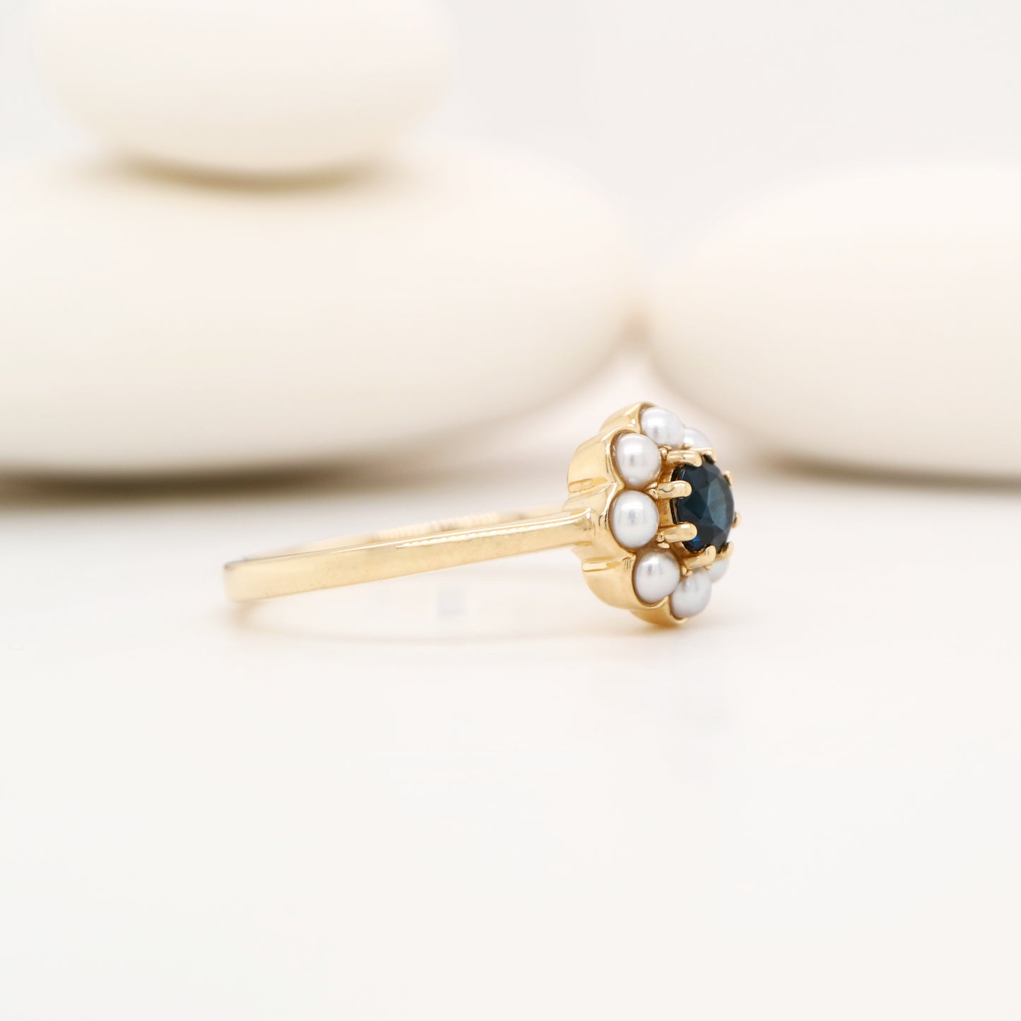 Blue sapphire with pearl halo ring in 9k yellow gold