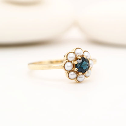 Blue sapphire with pearl halo ring in 9k yellow gold