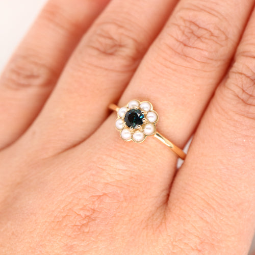Blue sapphire with pearl halo ring in 9k yellow gold