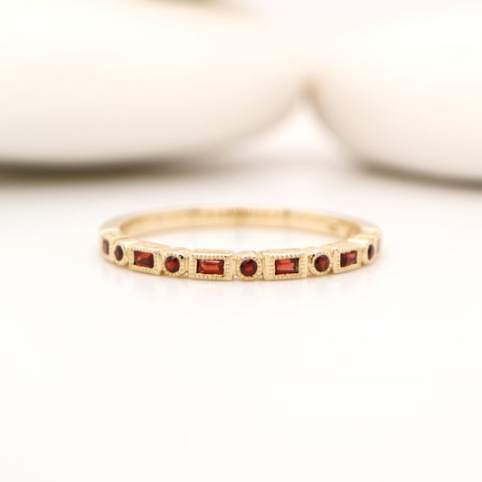 Art deco half set band in yellow gold with garnets