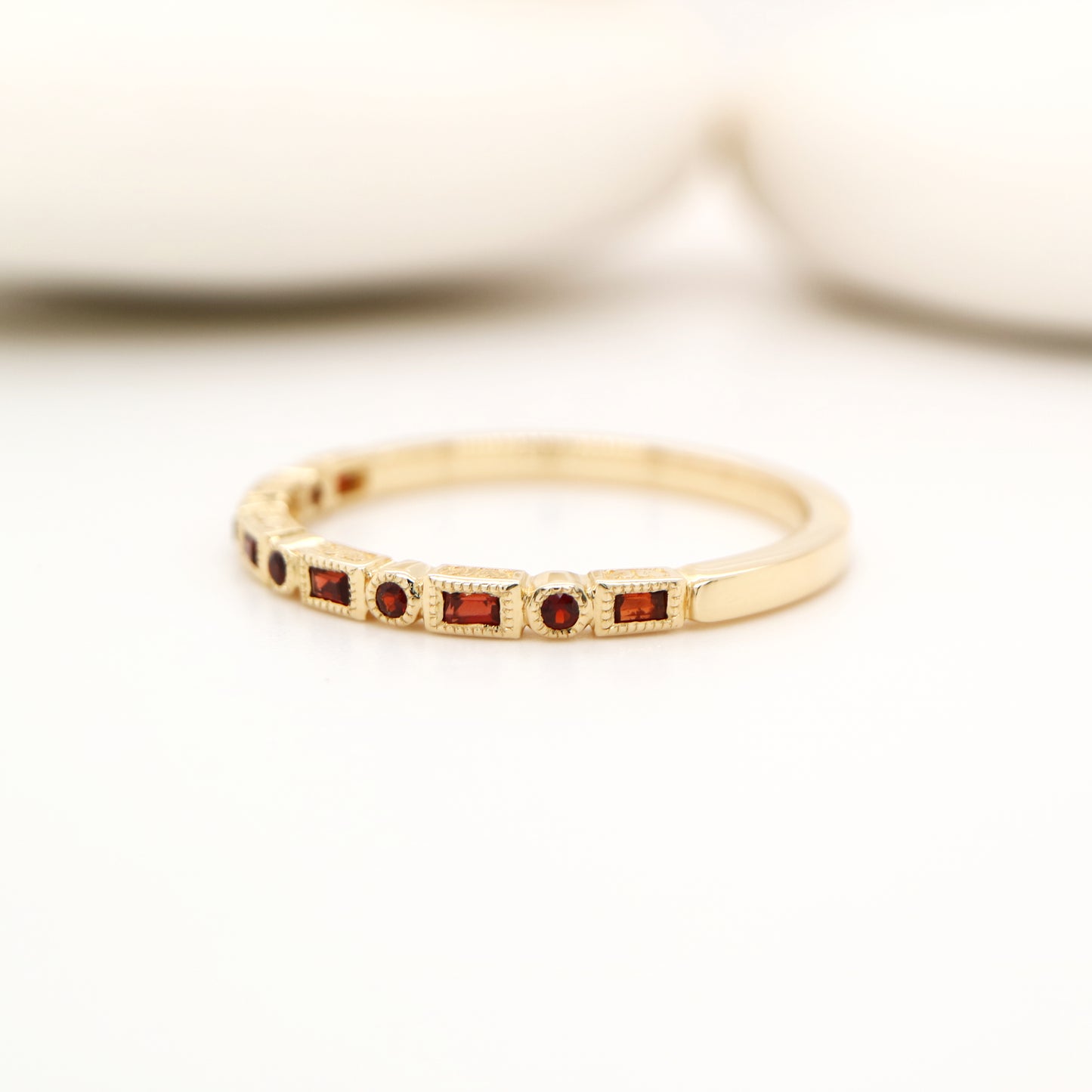 Art deco half set band in yellow gold with garnets
