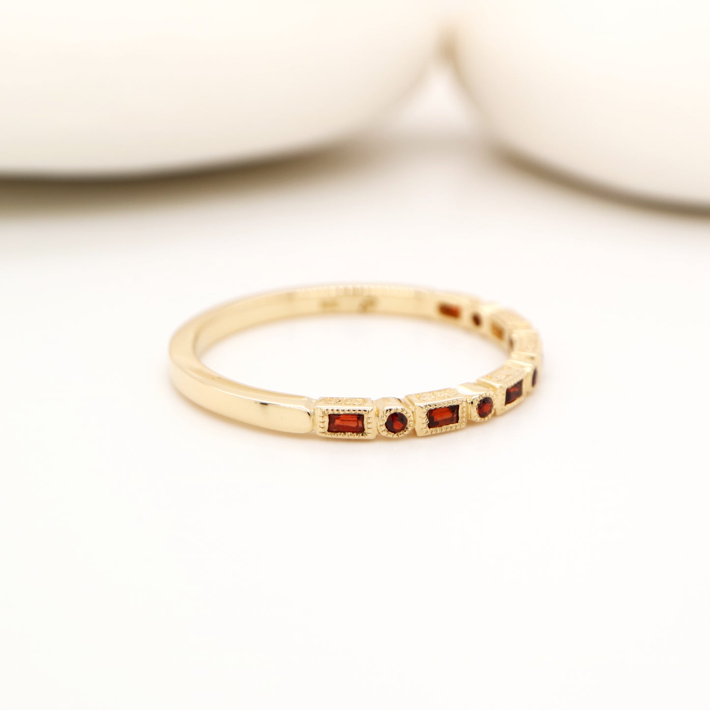 Art deco half set band in yellow gold with garnets