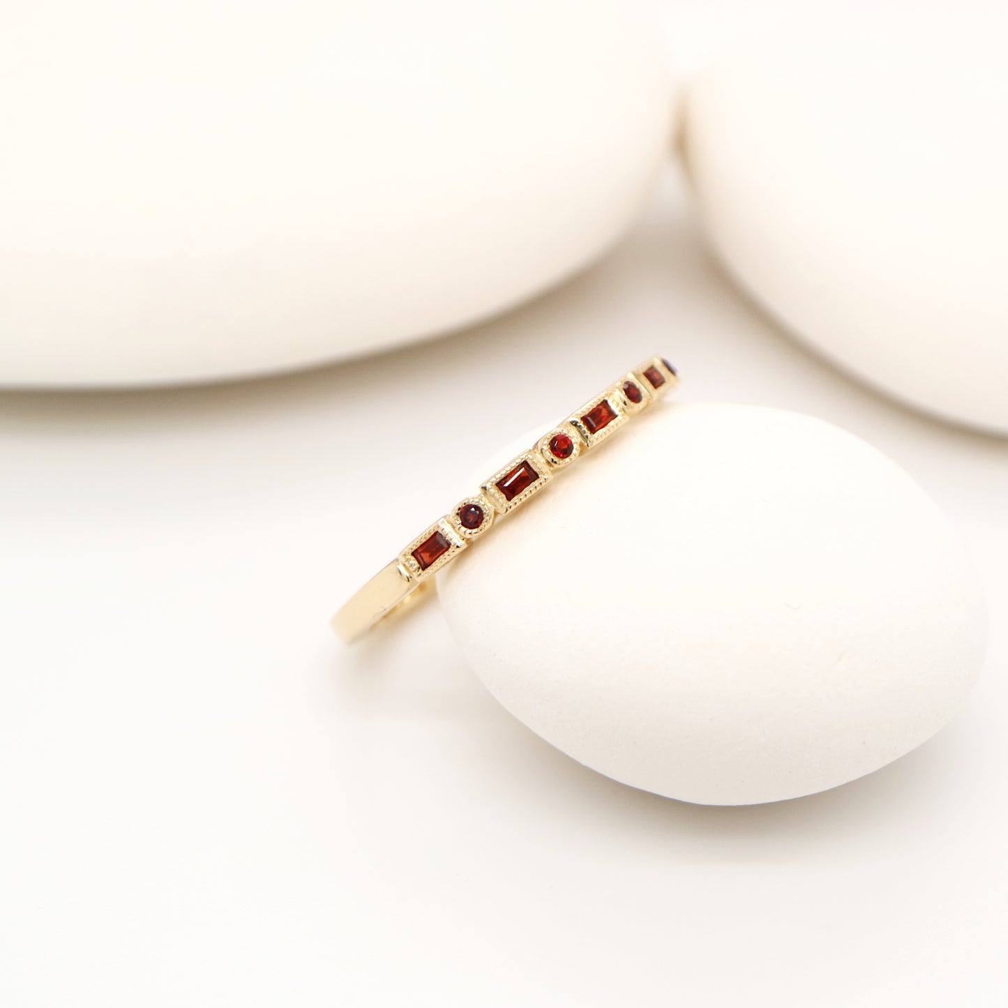 Art deco half set band in yellow gold with garnets