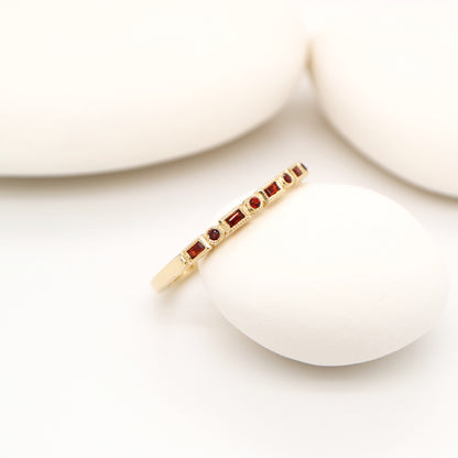 Art deco half set band in yellow gold with garnets