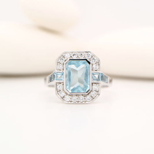 Aquamarine ring in gold with laboratory grown diamond halo