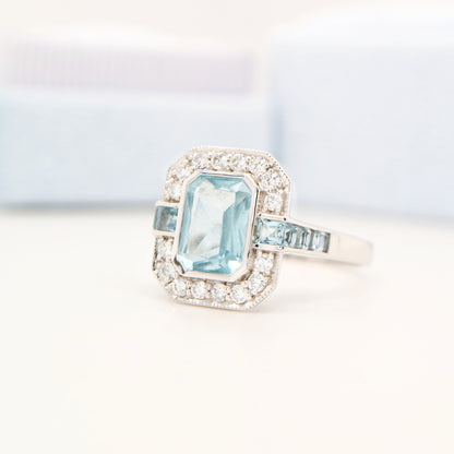 Aquamarine ring in gold with laboratory grown diamond halo