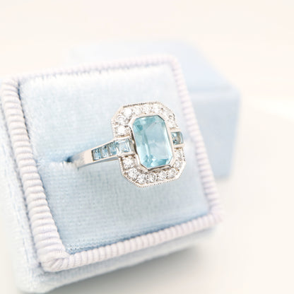 Aquamarine ring in gold with laboratory grown diamond halo