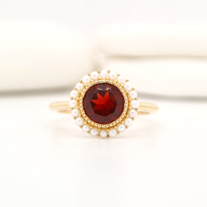 Colonial garnet filigree ring with pearl halo in yellow gold