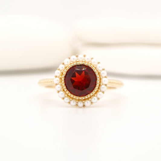Colonial garnet filigree ring with pearl halo in yellow gold