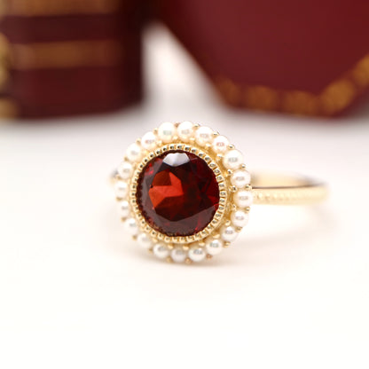 Colonial garnet filigree ring with pearl halo in yellow gold