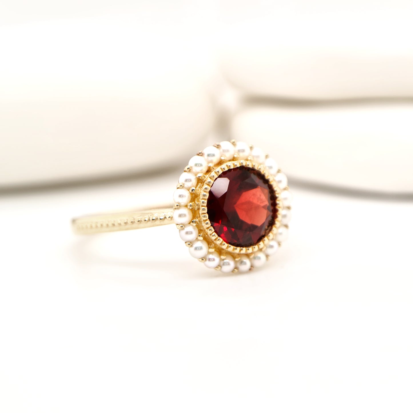 Colonial garnet filigree ring with pearl halo in yellow gold