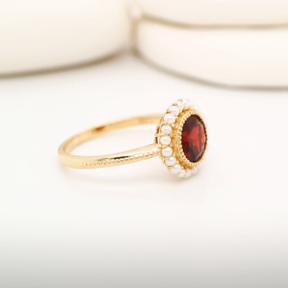 Colonial garnet filigree ring with pearl halo in yellow gold