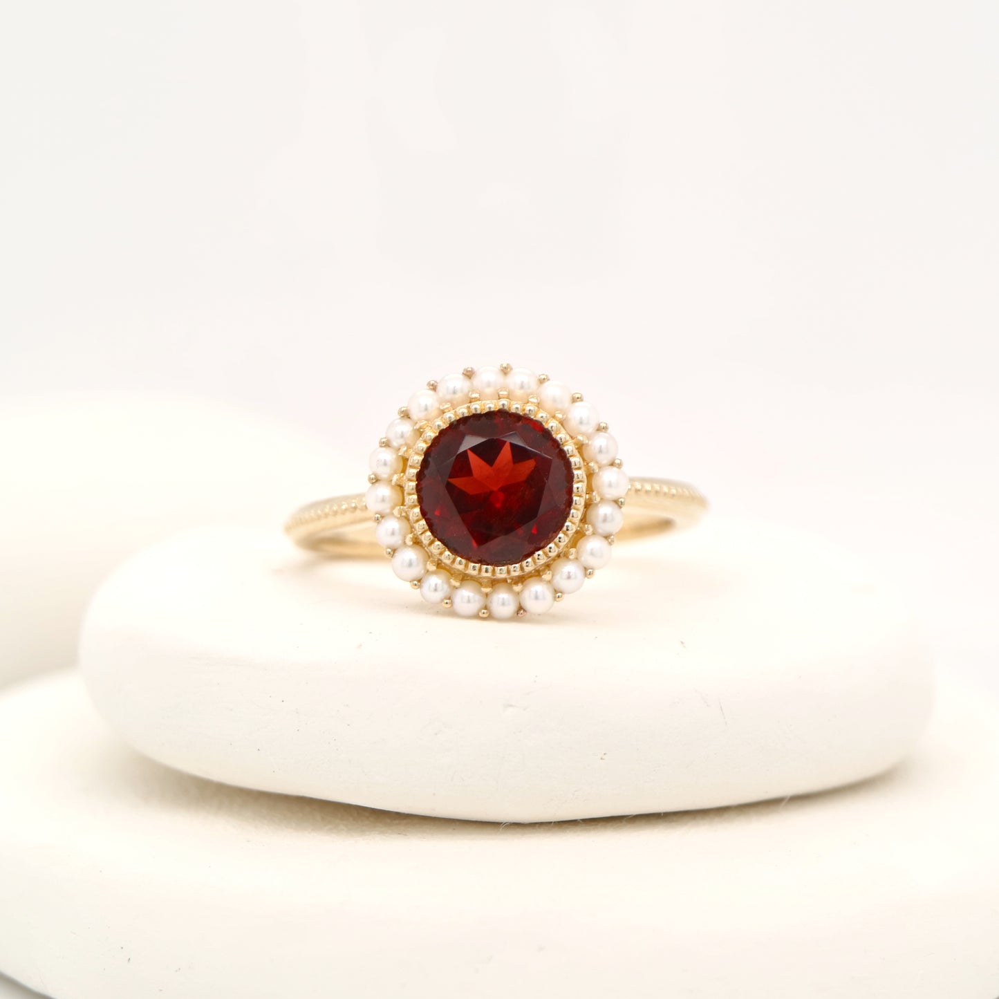 Colonial garnet filigree ring with pearl halo in yellow gold