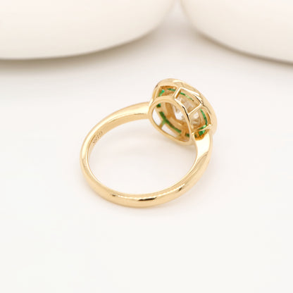 Moissanite with channel set emerald halo ring in yellow gold
