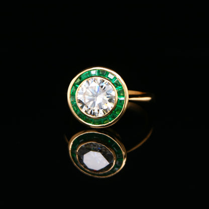 Moissanite with channel set emerald halo ring in yellow gold