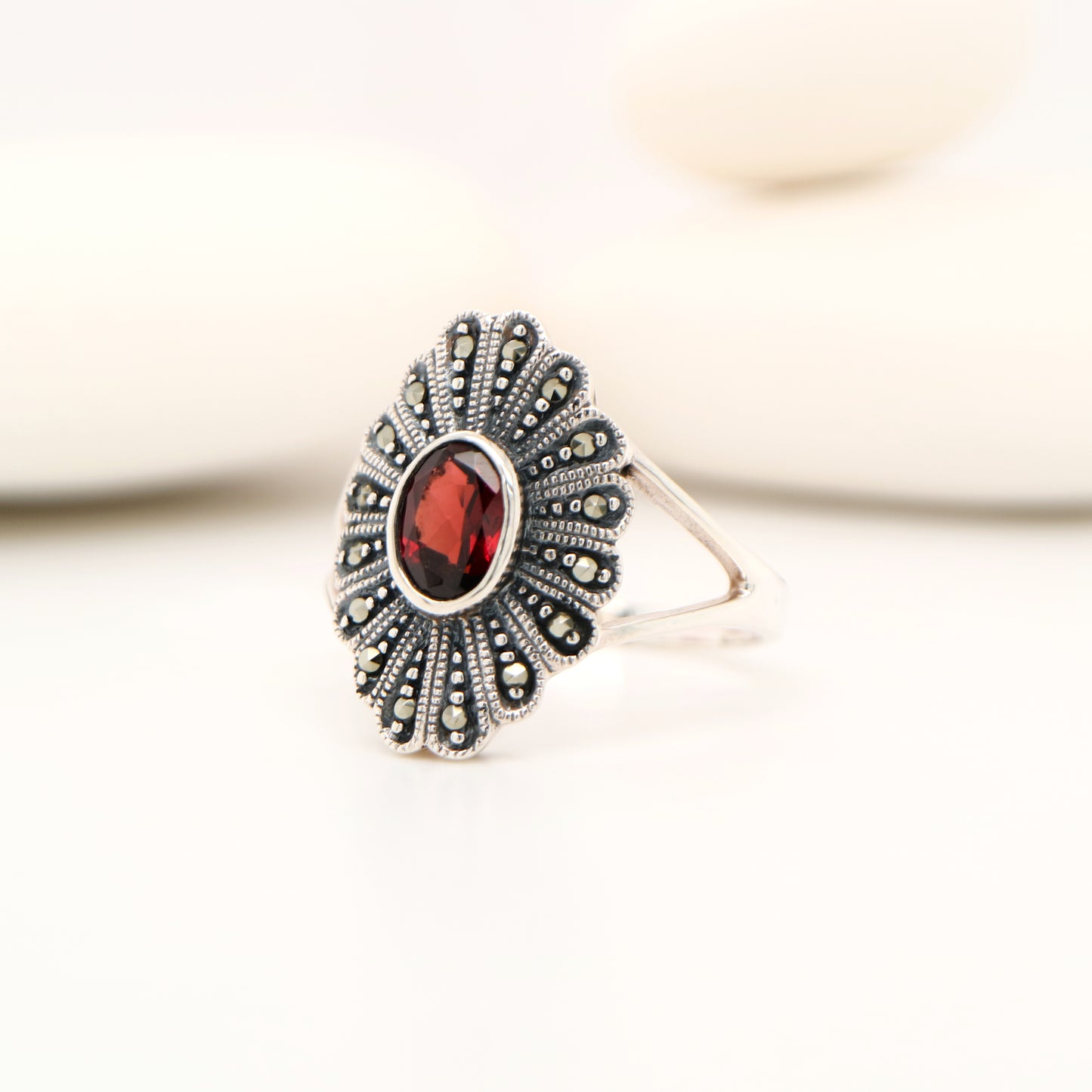 Marcasite shield with garnet ring in sterling silver