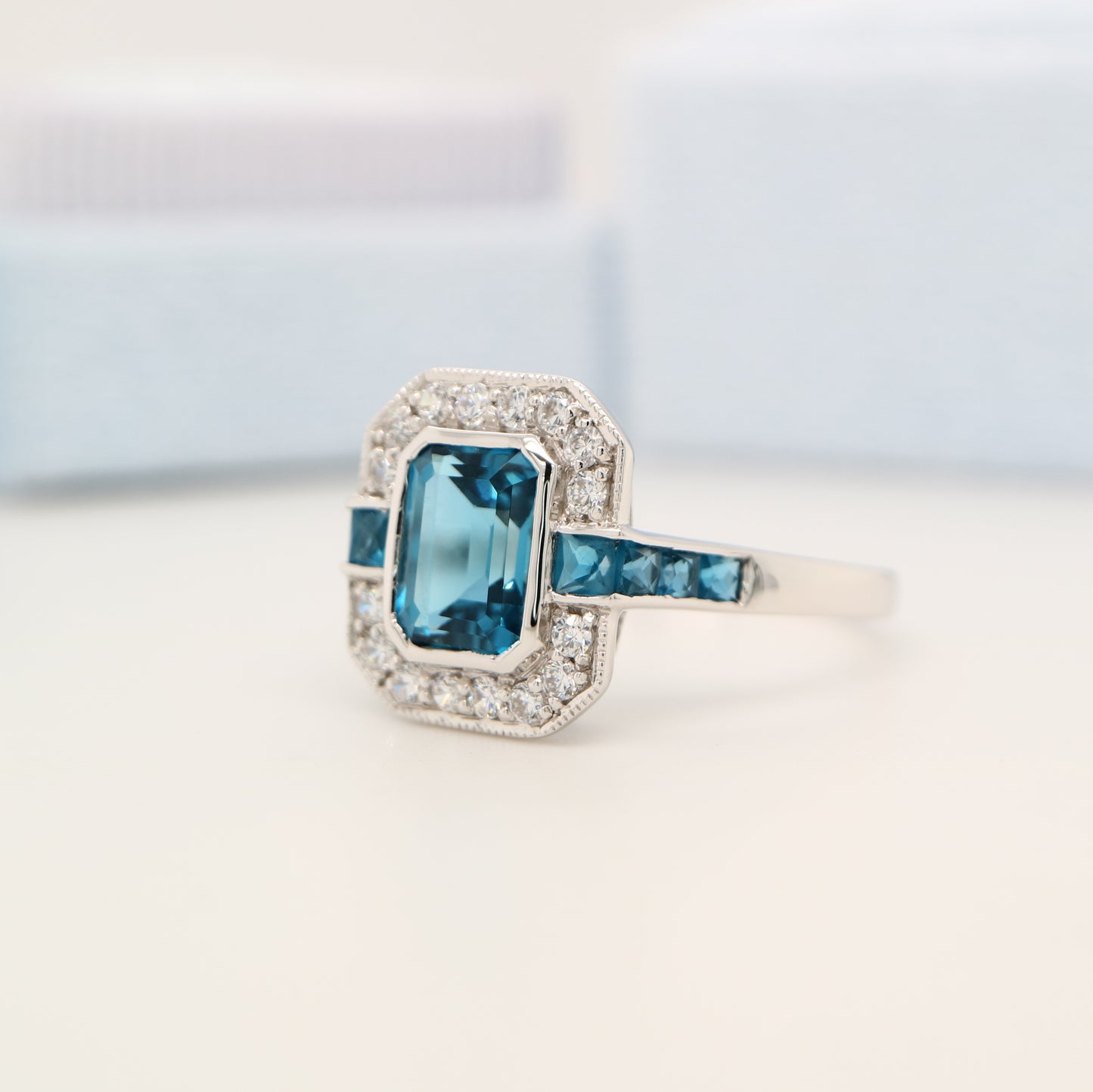 London blue topaz ring in Sterling Silver with CZ halo