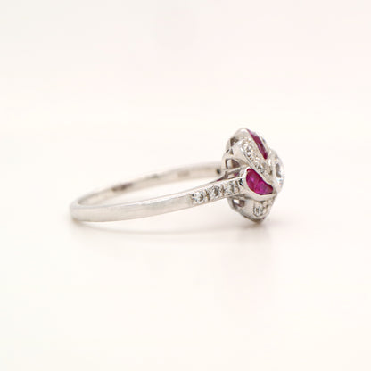 Silver ring with red gemstone on white background