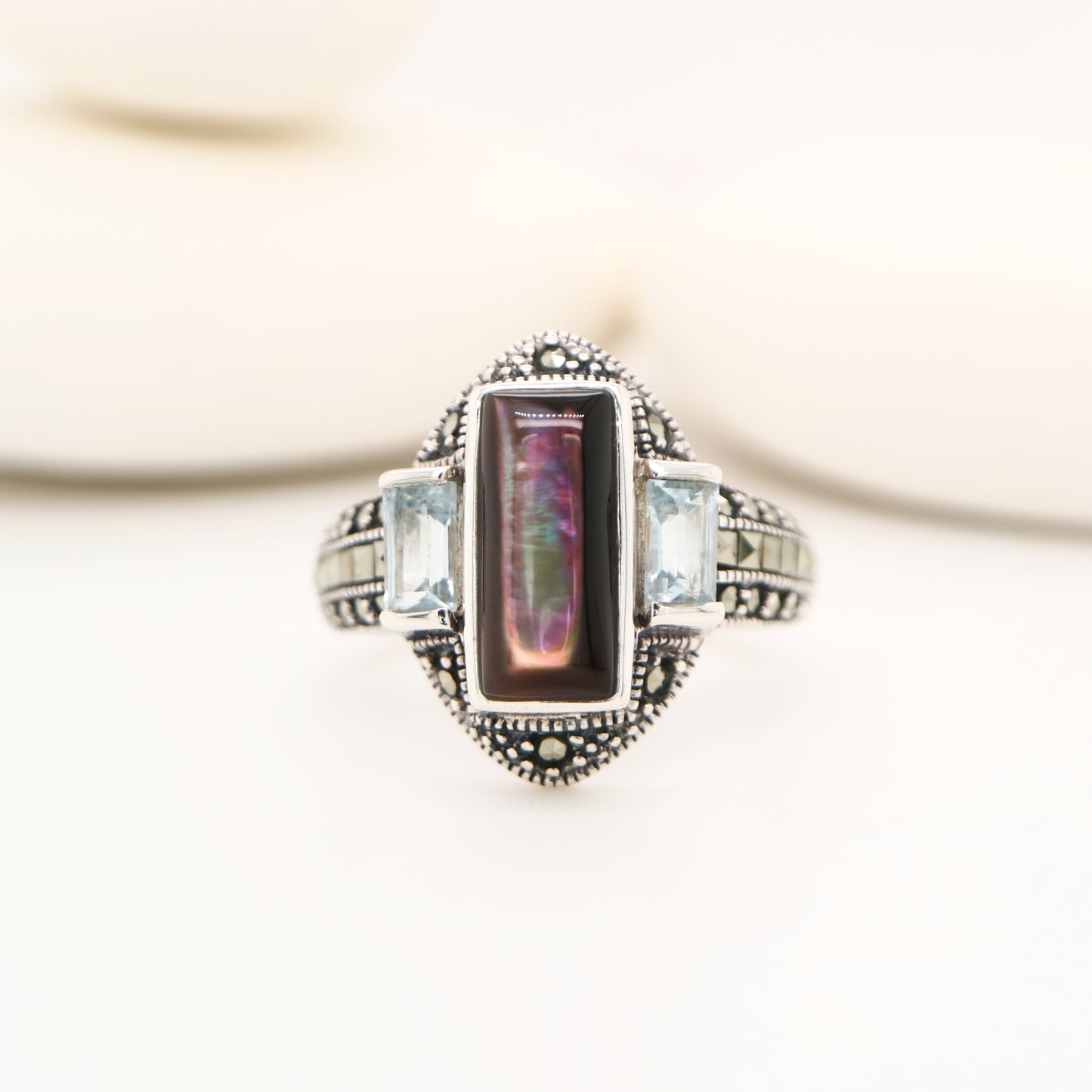Silver lipped grey shell and pale blue topaz ring with marcasite in sterling silver