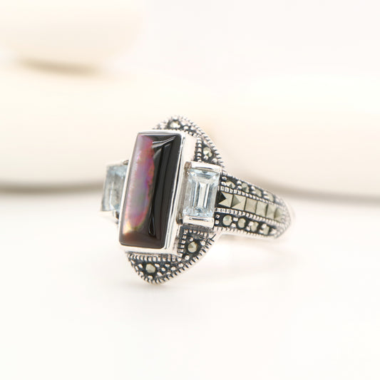 Silver lipped grey shell and pale blue topaz ring with marcasite in sterling silver