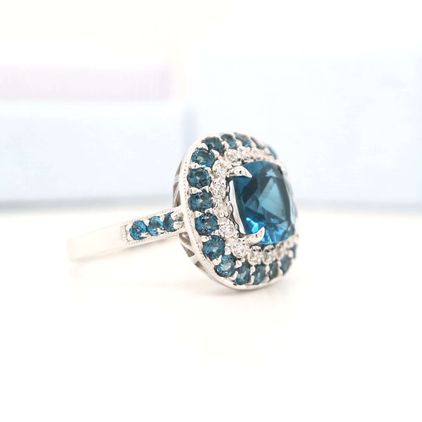 London blue topaz cocktail ring with cz and london blue topaz halo in sterling silver
