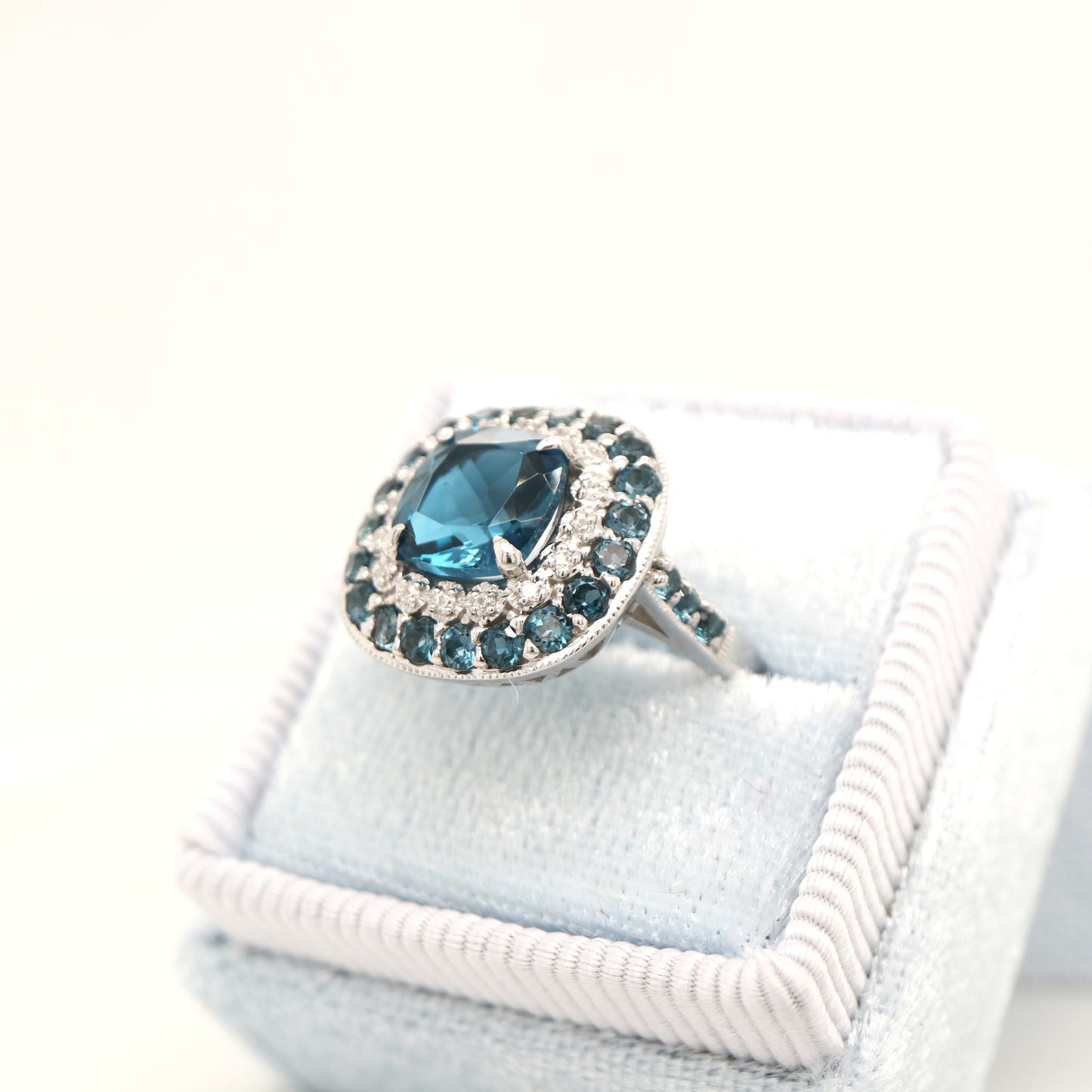 London blue topaz cocktail ring with cz and london blue topaz halo in sterling silver