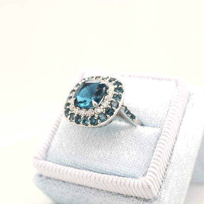 London blue topaz cocktail ring with cz and london blue topaz halo in sterling silver