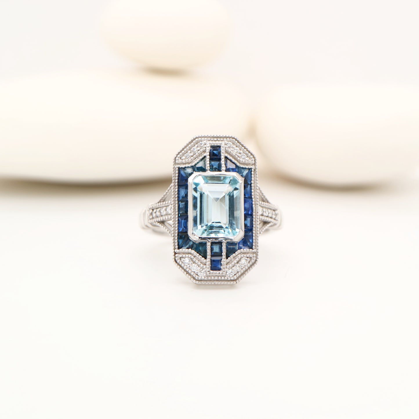 Art deco aquamarine cocktail ring with sapphire halo in white gold