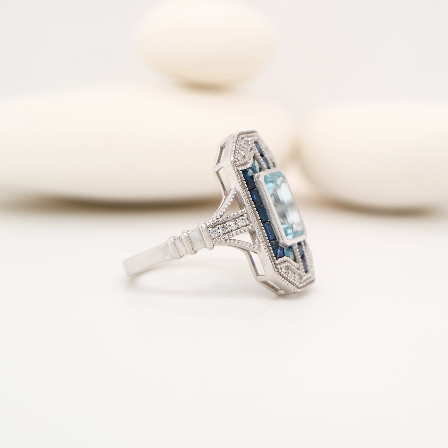 Art deco aquamarine cocktail ring with sapphire halo in white gold