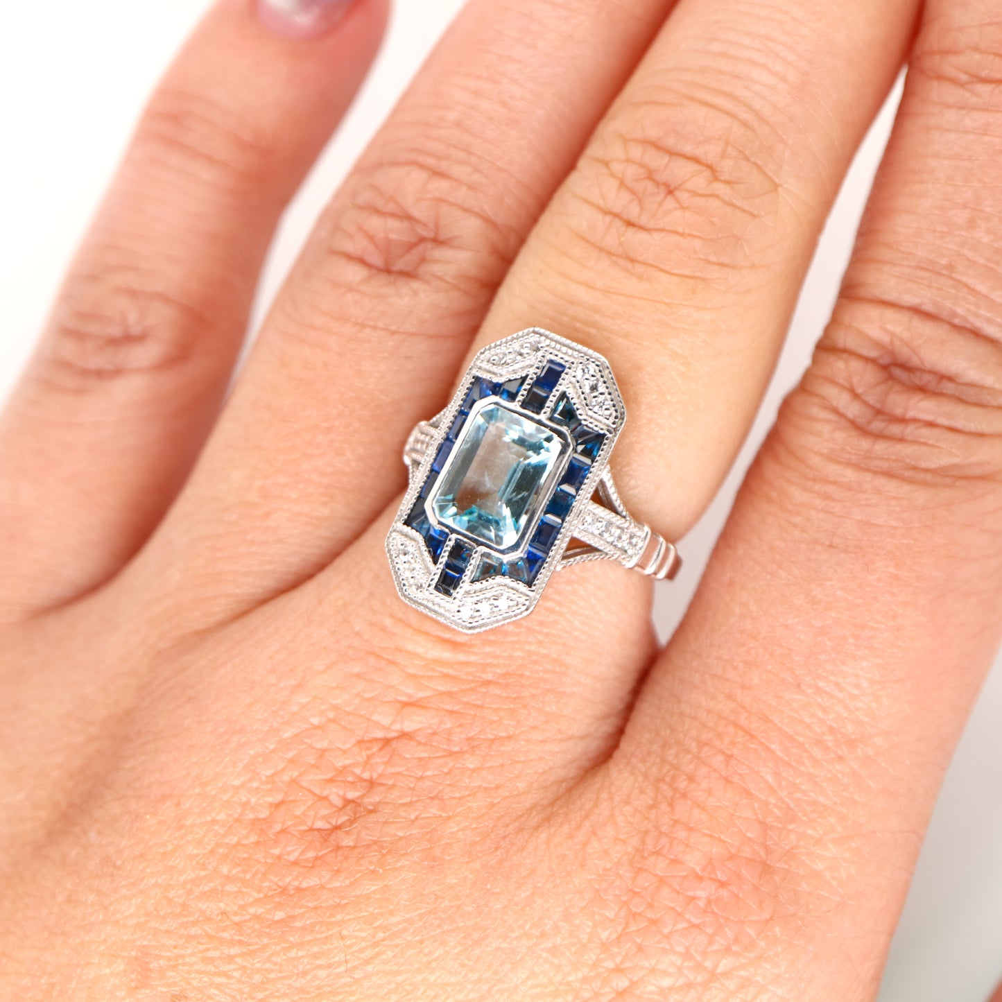 Art deco aquamarine cocktail ring with sapphire halo in white gold