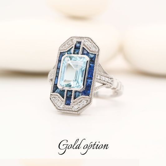 Art deco aquamarine cocktail ring with sapphire halo in white gold